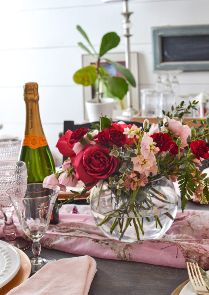 A romantic flower arrangement for Valentines Day with red and pink roses, and dark red carnations