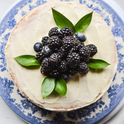 Top view of a cake decorated with fresh blueberries and blackberries