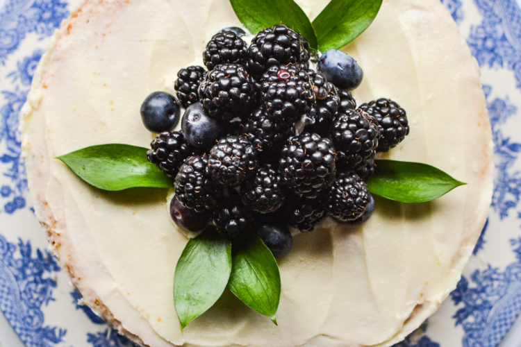 Top view of a cake decorated with fresh blueberries and blackberries