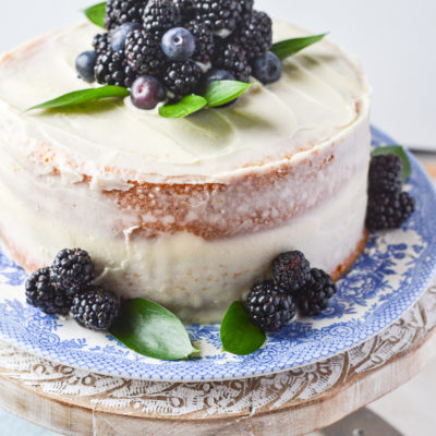Berry Semi Naked Cake garnished with blackberries and blueberries.
