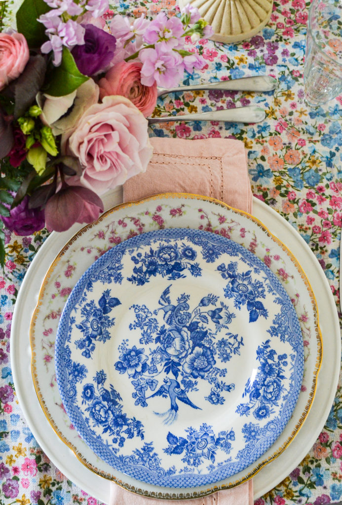 pink floral and blue floral plates stacked on a simple white dinner plate