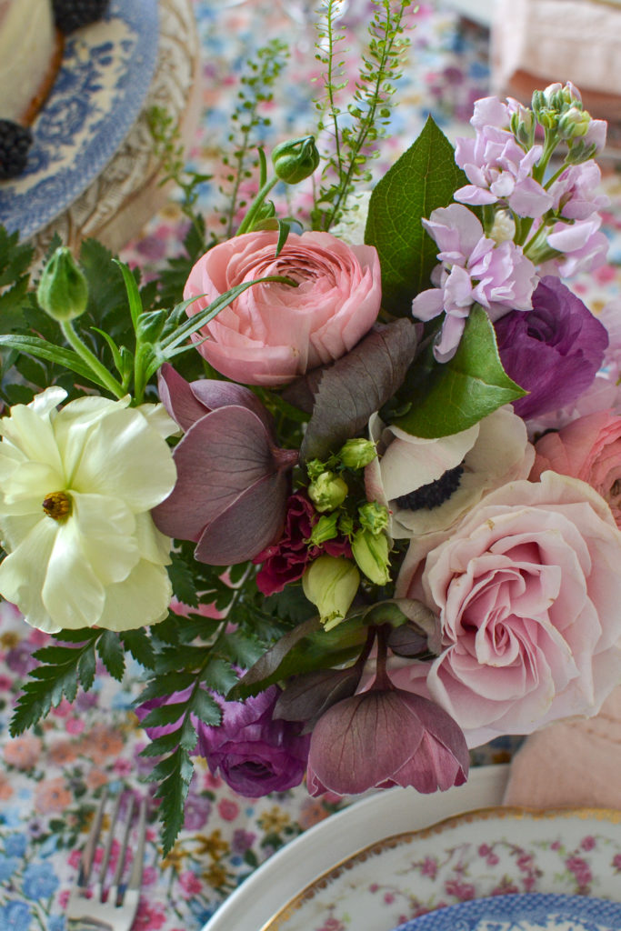small posy of ranunculus, roses, and anemones