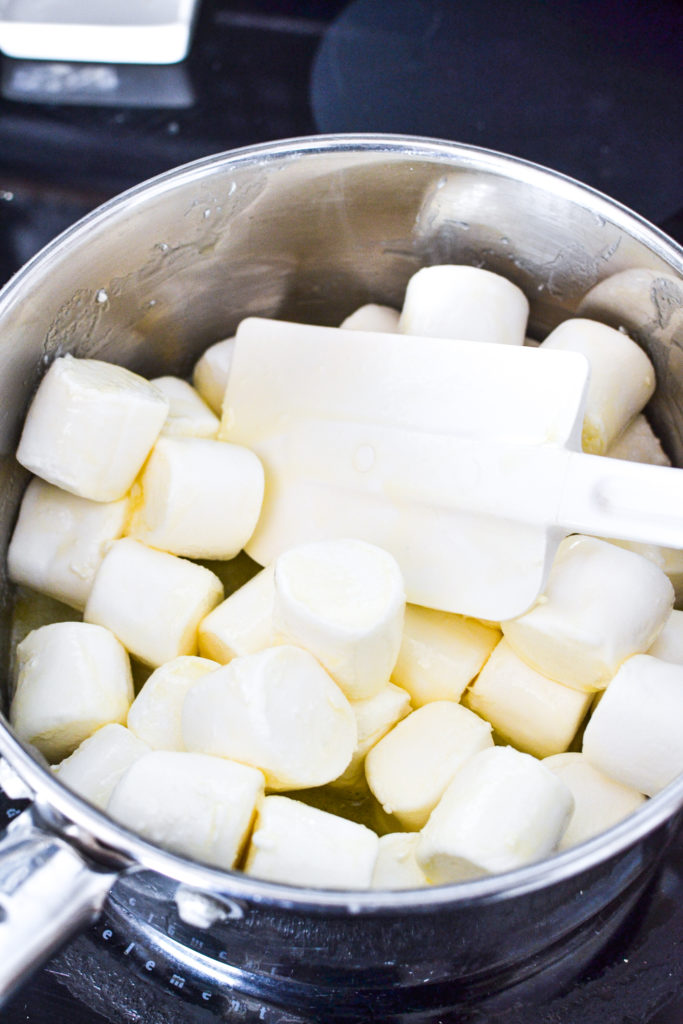 Melting marshmallows with butter to make shredded wheat Easter nests