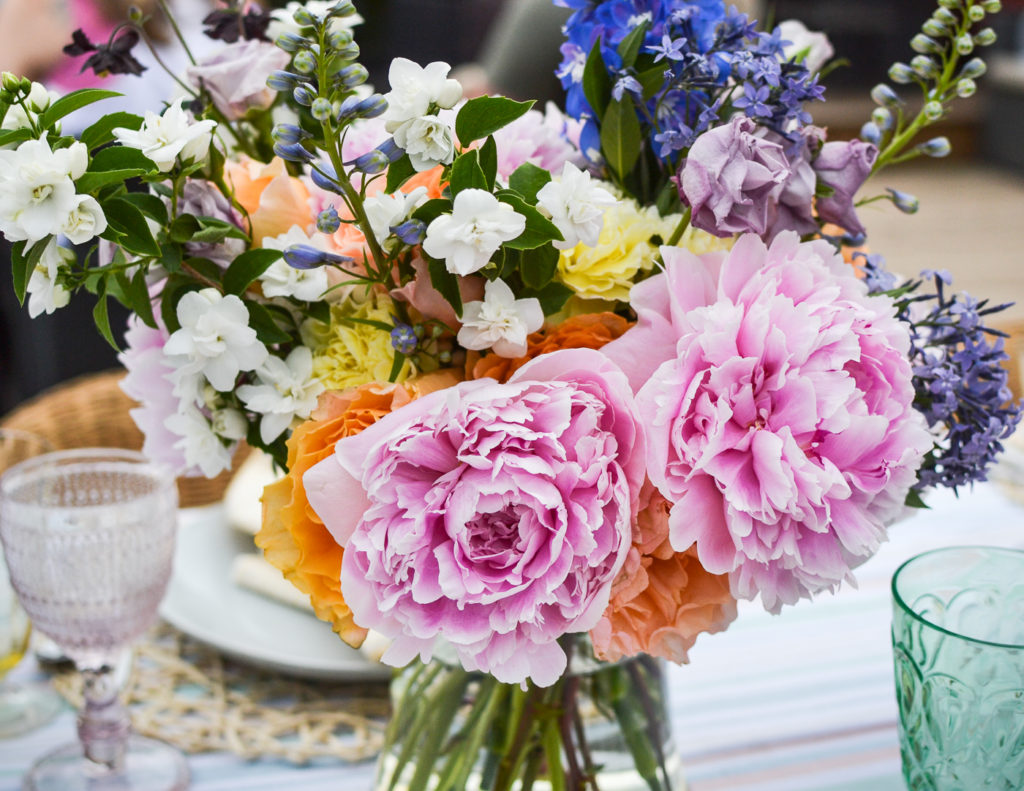 fresh flower centrepiece made peonies, mock orange blossom, and other garden flowers