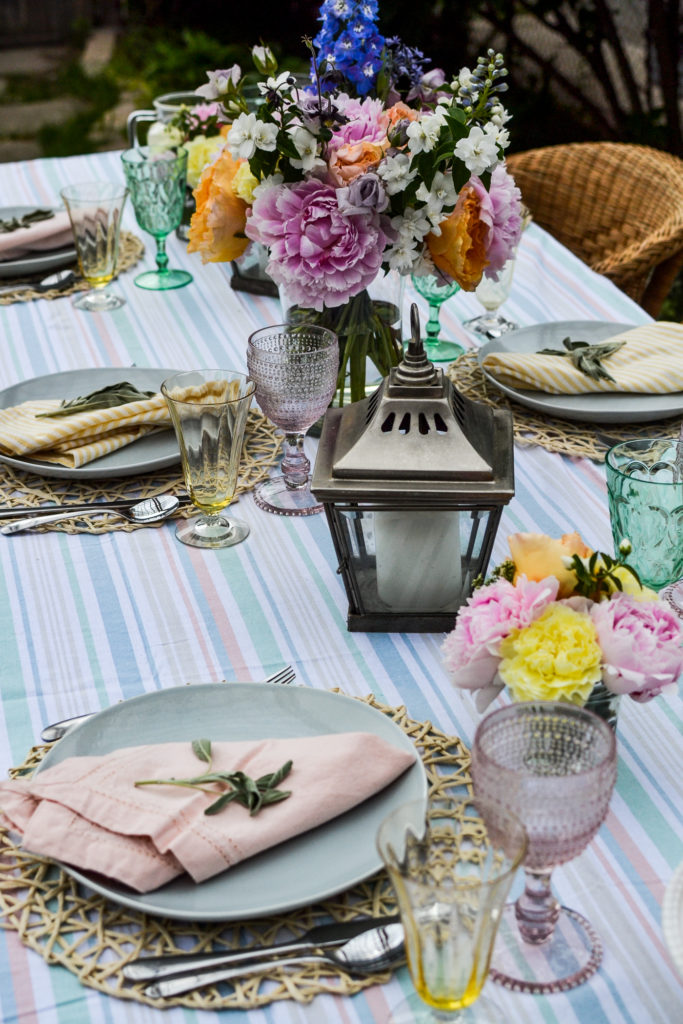 mixed matched tableware for outdoor dining in shades of pink green and yellow