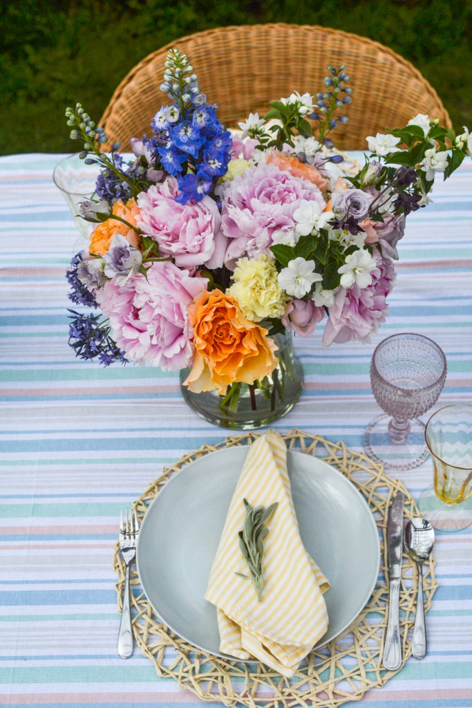 Overhead view of a floral centrepiece and pacesetting on an outdoor table