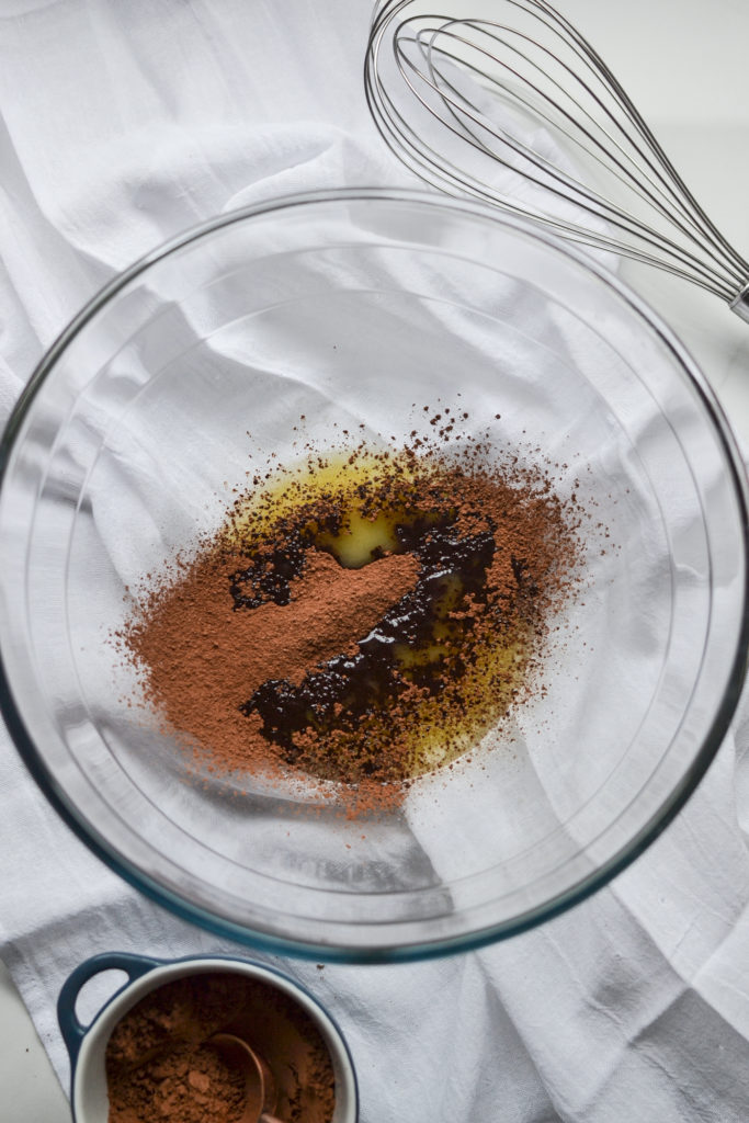 melted butter and cocoa in a clear mixing bowl