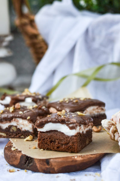 Fudgey marshmallow brownies on a wood board