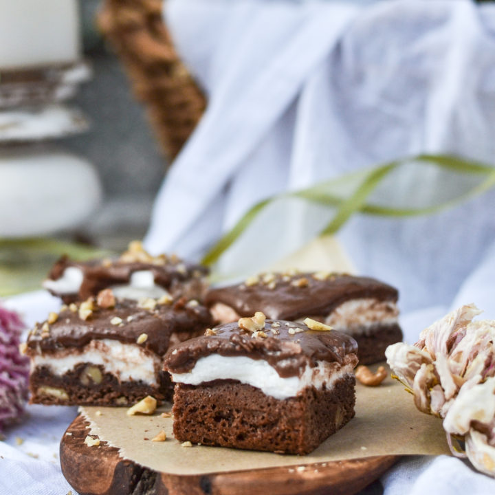 Fudgey marshmallow brownies on a wood board