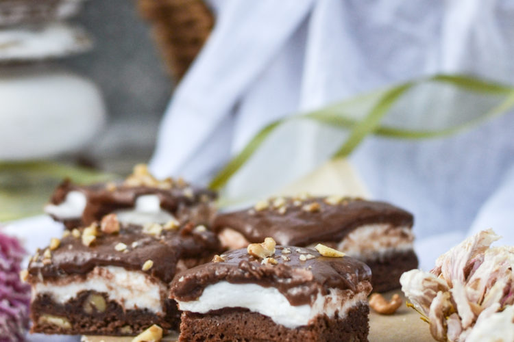 Fudgey marshmallow brownies on a wood board