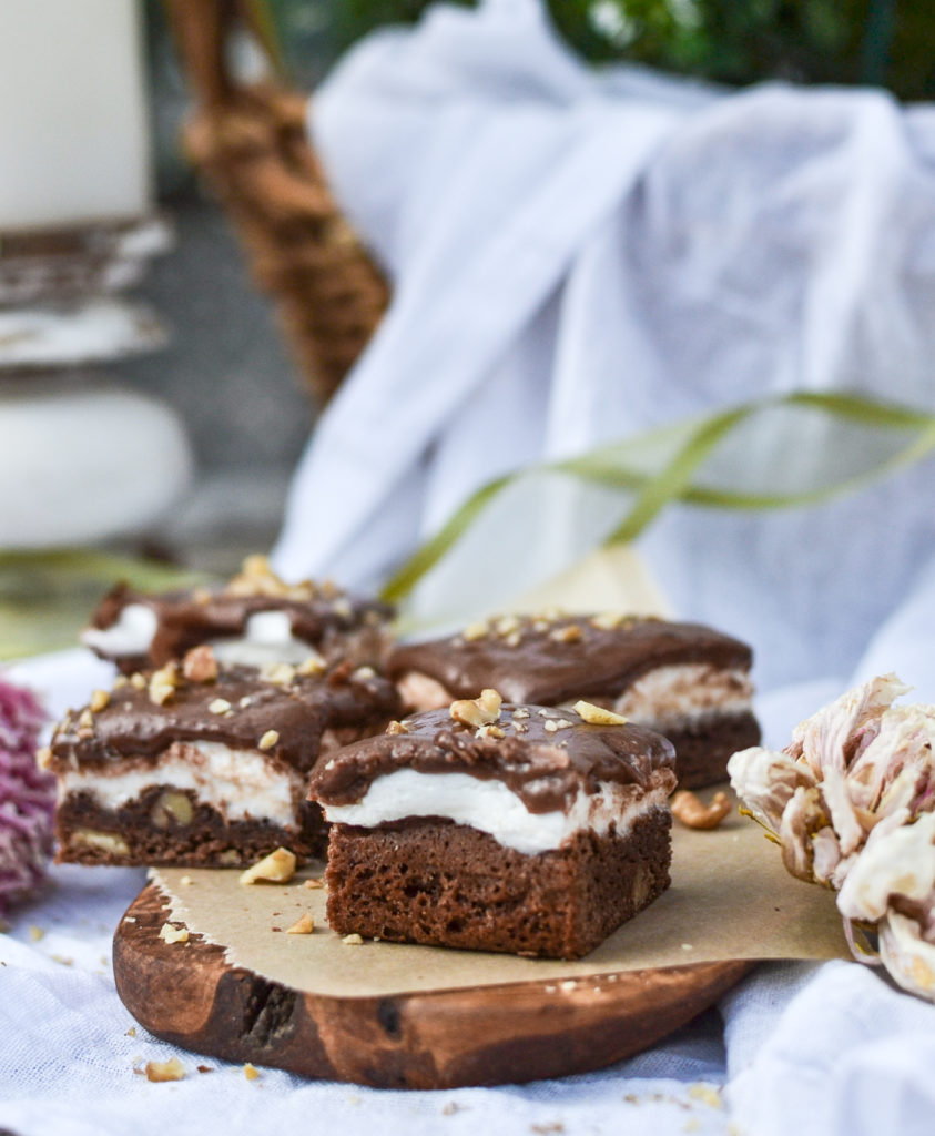 Fudgey marshmallow brownies on a wood board