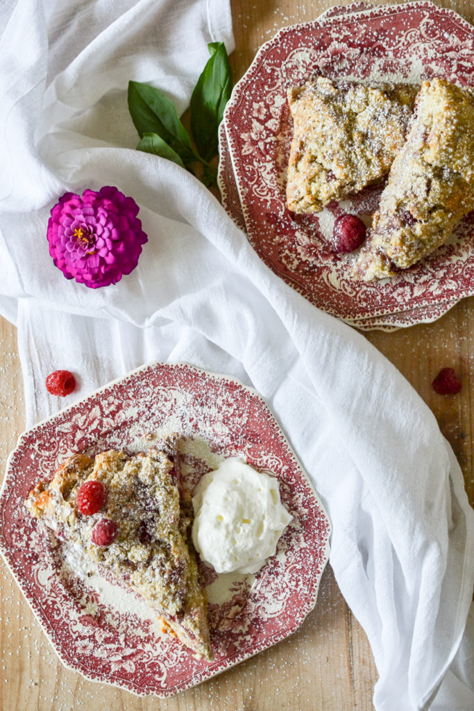 overhead view of raspberry scones on red and white transfer ware plates