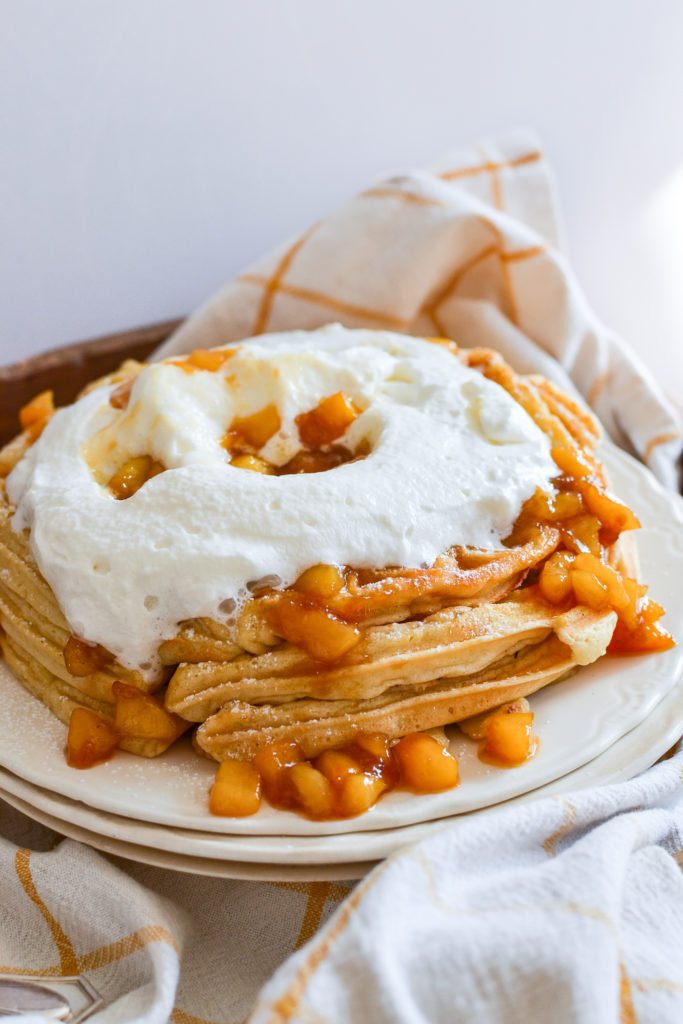 fluffy peach waffles with whipped cream