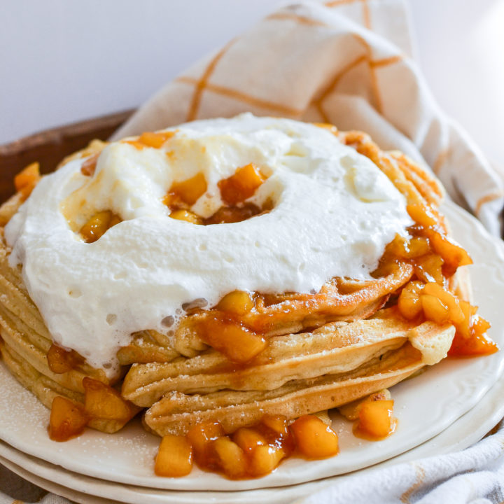 fluffy peach waffles with whipped cream