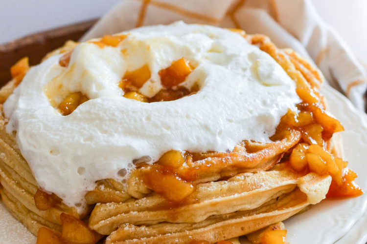 fluffy peach waffles with whipped cream