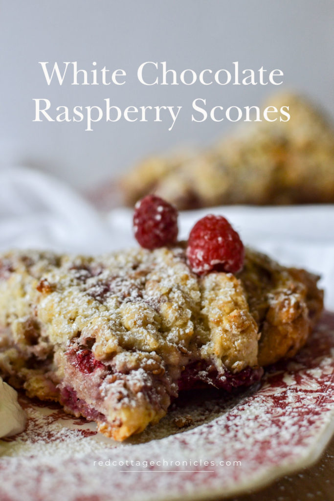 Raspberry Scone dusted with icing sugar on a red transferware plate