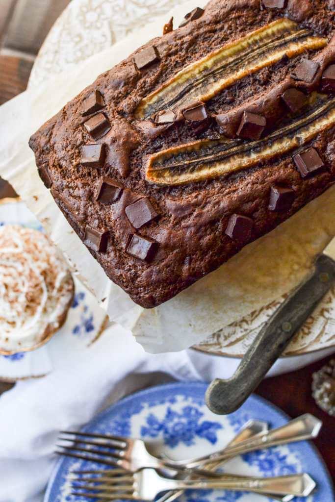 Double chocolate banana bread ready to serve with a cup of hot chocolate