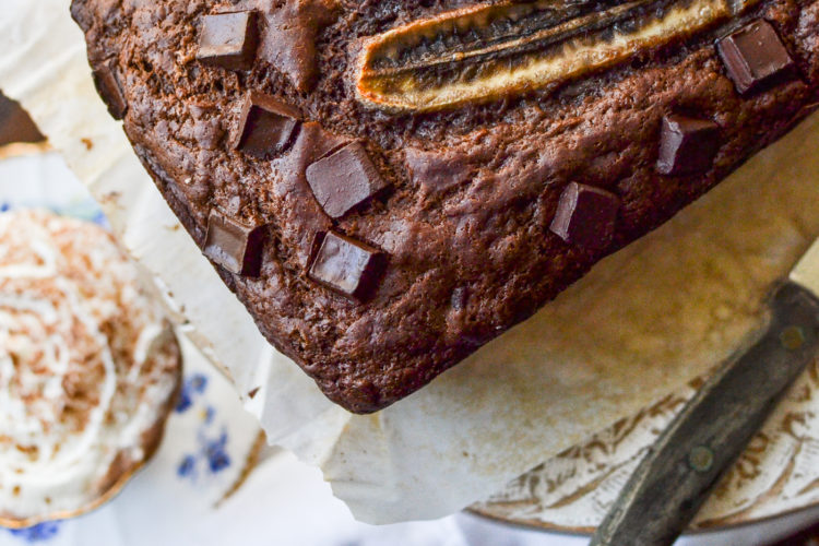 Double chocolate banana bread ready to serve with a cup of hot chocolate