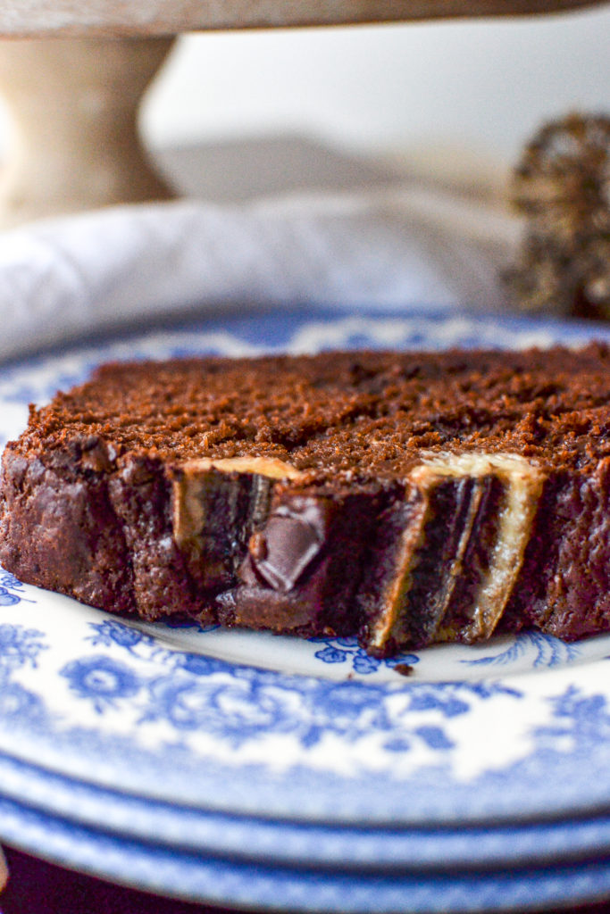 A slice of chocolate banana bread on a blue transfer ware plate