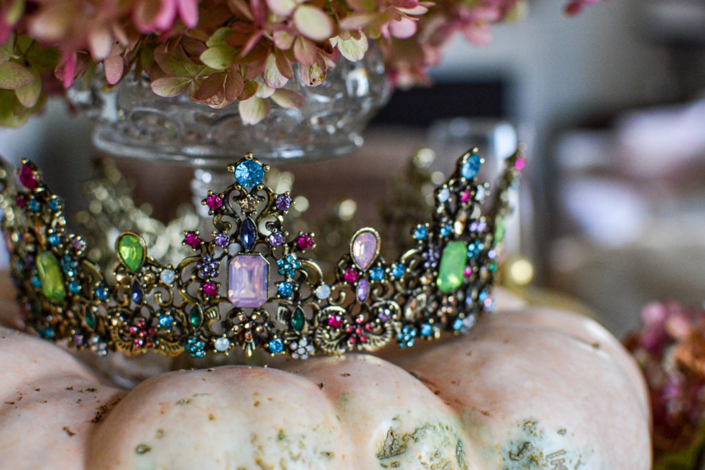 Colourful crown on top of a pink pumpkin for a Halloween Tablescape