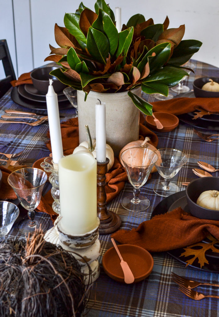 a table set for Thanksgiving in shades of blue, terracotta and brown.