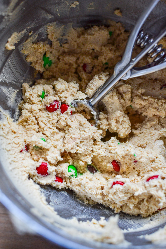 A mixing bowl filled with peanut butter m&m cookie dough