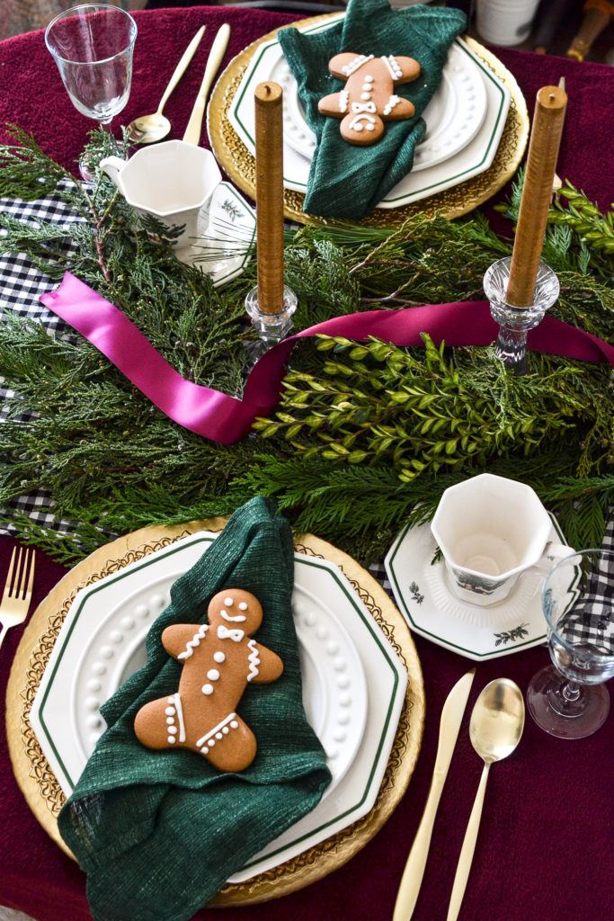 A Christmas tablescape decorated in cranberry, gold and green.