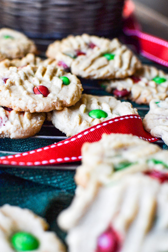 A cooling rack with peanut butter and m&m cookies.