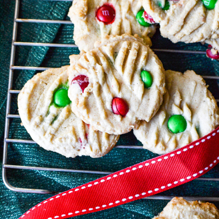 An overhead view of peanut butter m&m cookies made with festive red and green m&ms.