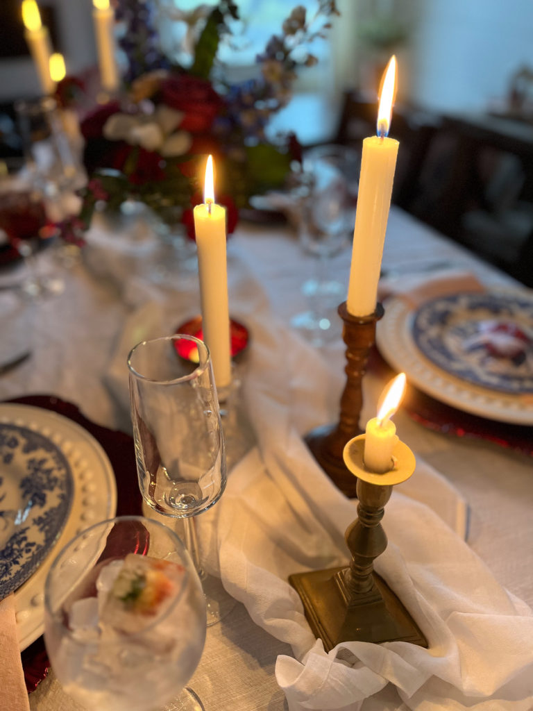 3 candles flickering on a Valentines tablescape.