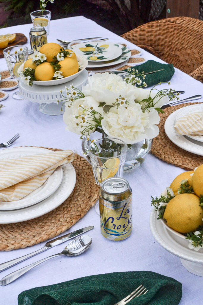 Lemon themed tablescape with a centrepiece of white peonies.