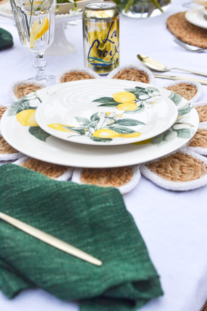 Lemon themed dinner plates on an outdoor table.
