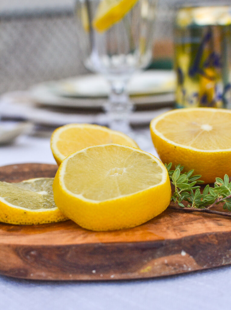 A cutting board with slices of fresh lemon.