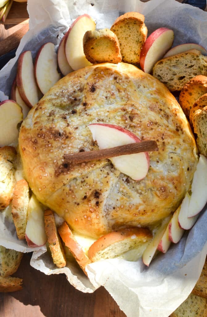 An overhead view of brie baked in puff pastry with apple and cinnamon.