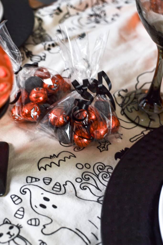 Cellophane bags of halloween candy on a table.