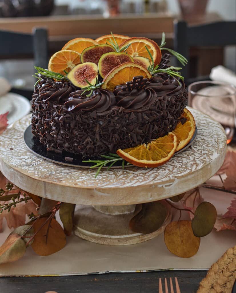 Chocolate layer cake decorated with figs and dried orange slices.