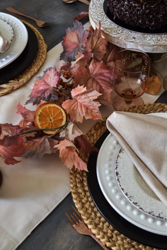 Faux leave garland in shades of orange for fall.