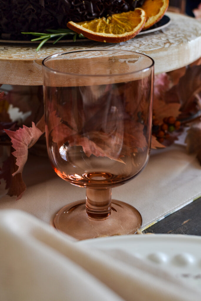 An amber coloured stemmed wine glass