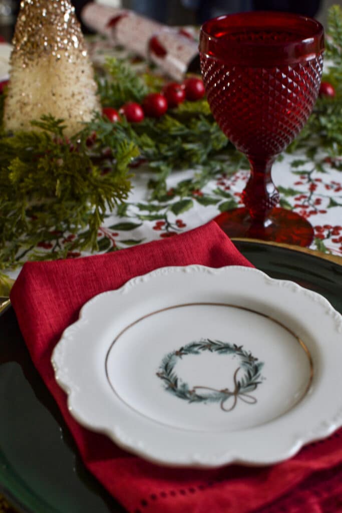 White appetizer plate with a gold and green Christmas wreath motive