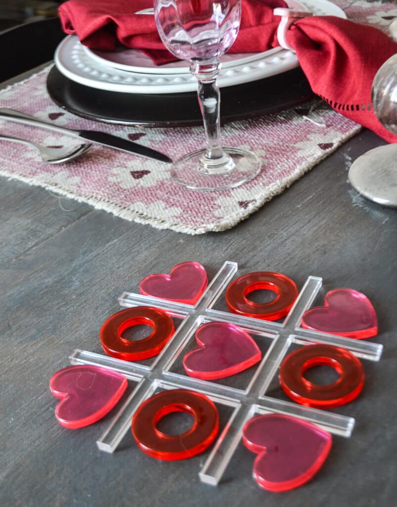 Family Valentines Day ideas like this pink and red tic tac toe board using hearts and O's.