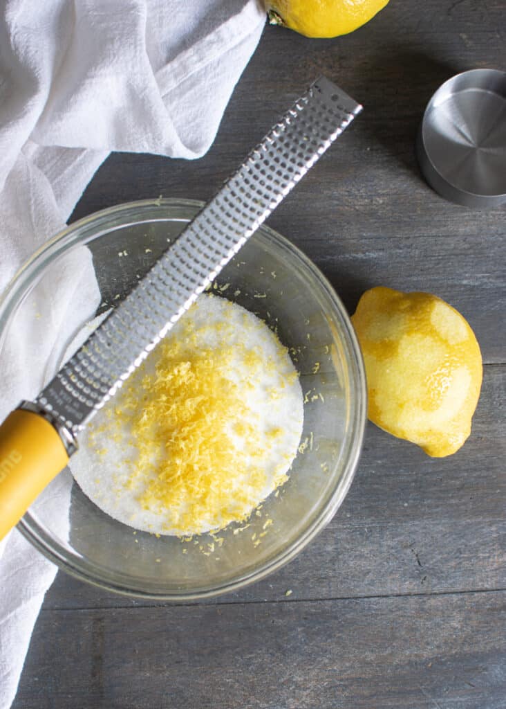 Zest lemon rind into sugar