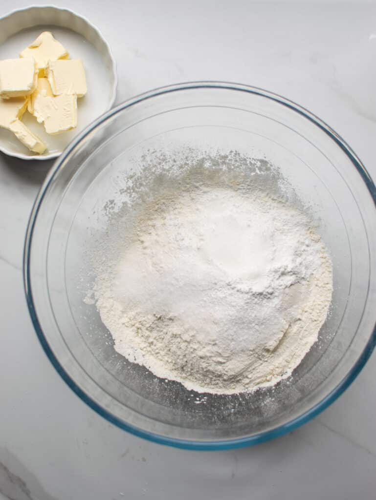 Dry ingredients for no-yeast cinnamon rolls in a glass bowl
