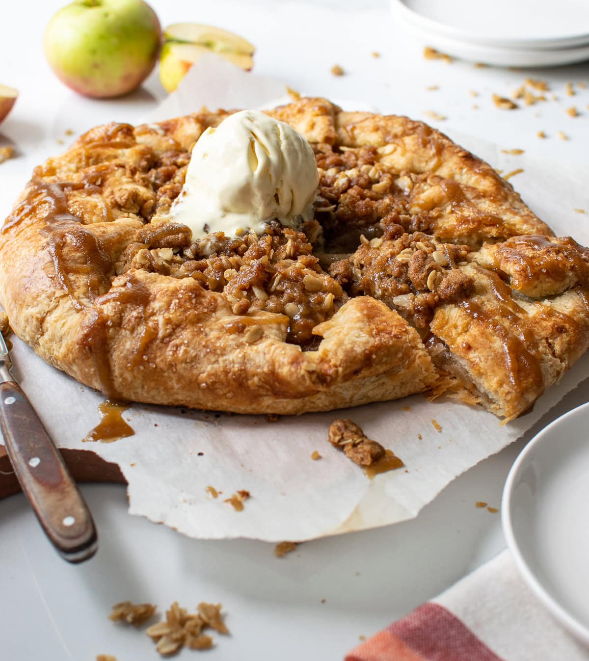 A pear and apple galette with a scoop of ice cream on top.
