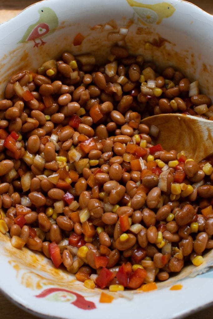 Barbecue dressing added to bean mixture to make baked bean salad.