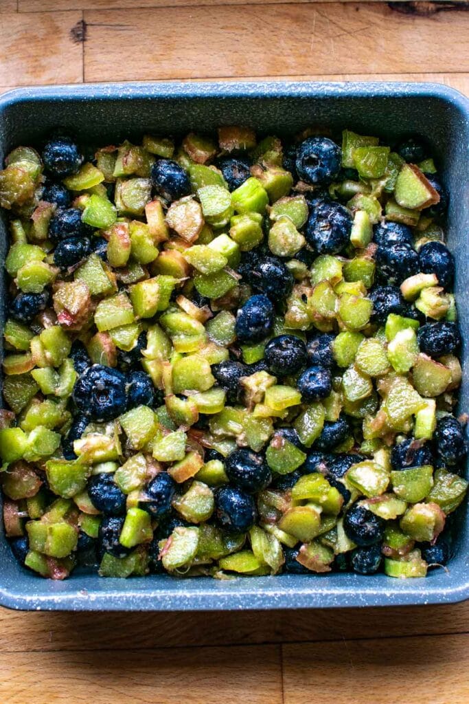 Filling for fruit crisp in an 8 inch square baking pan before adding crumble topping.