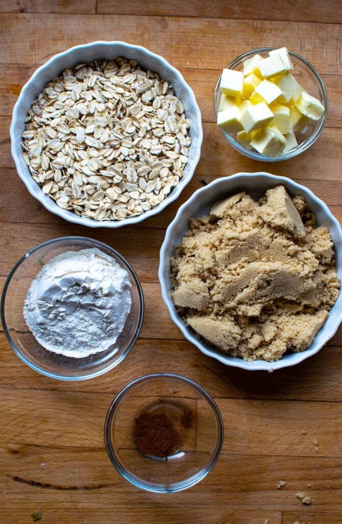 Ingredients to make the topping for a rhubarb blueberry crisp including oats and brown sugar.