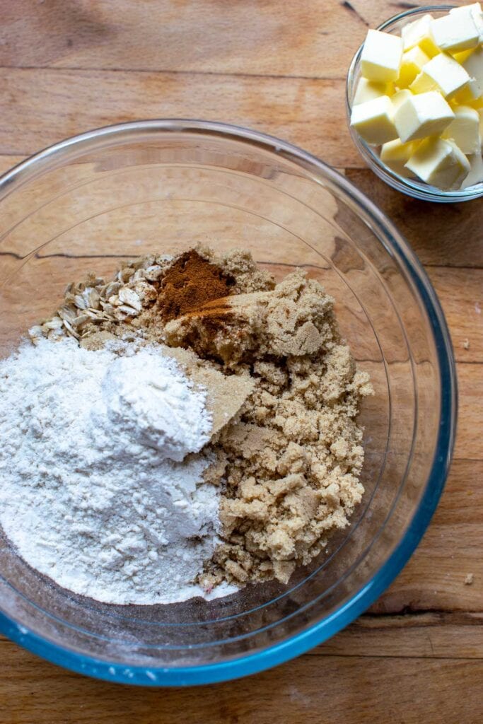 Dry ingredients for crumble topping in a glass bowl before being mixed together.