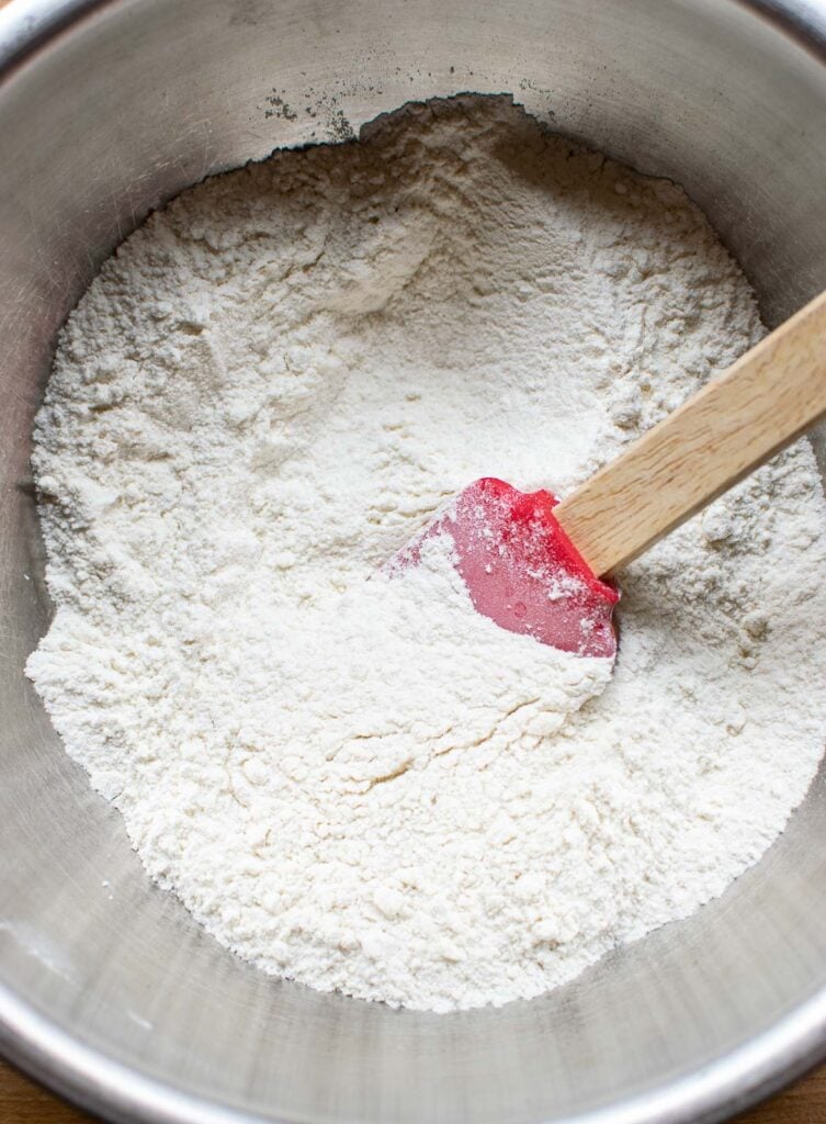 Dry ingredients for muffins mixed together in a metal mixing bowl.