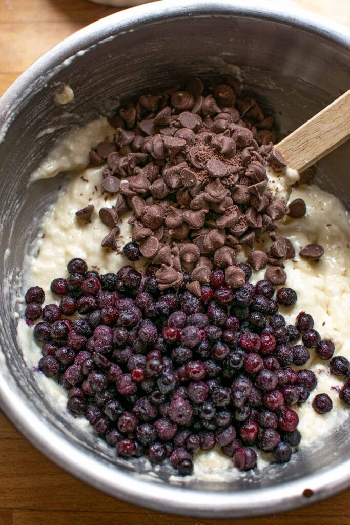 Milk chocolate chips and frozen blueberries added to muffin batter.