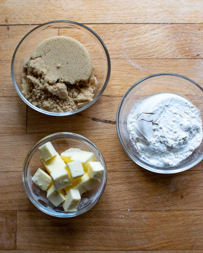 Ingredients to make crumble topping for muffins including brown sugar, flour and butter.